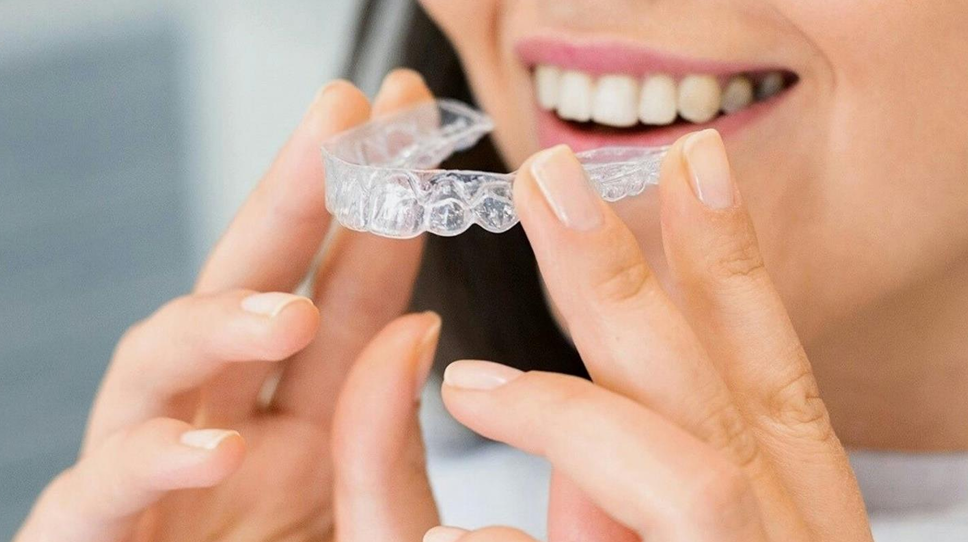 Woman inserting clear aligner